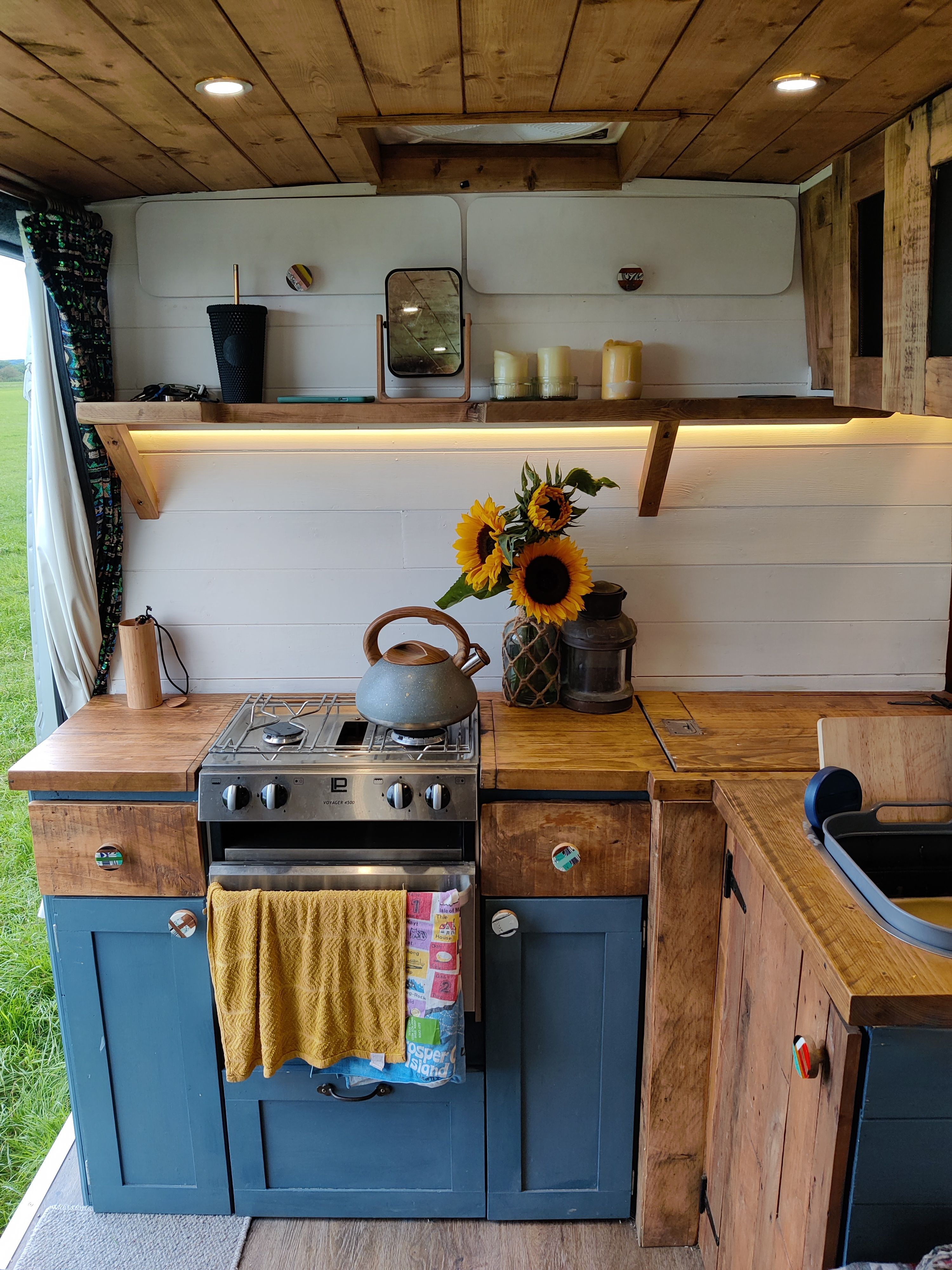 Cosy campervan sleeping space with wool and timber